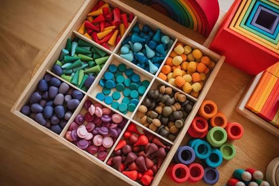 Wooden sorting tray filled with colourful wooden pieces and rings