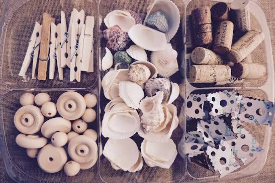 Tray of seashells, wine corks, wooden pegs and wooden beads